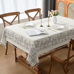 a dining room table set with place settings