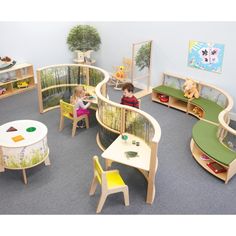 children's play area with tables, chairs and bookshelves on the floor