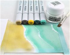 some watercolor paints are sitting on top of a piece of paper