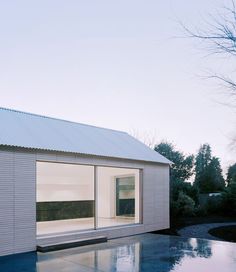 a white house sitting on top of a wet pool