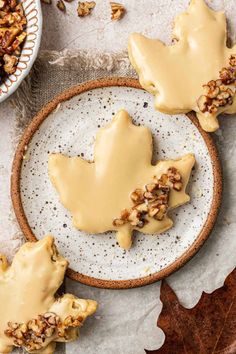 some cookies are sitting on a plate with maple leaves