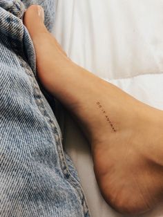 a person's foot with the word love written on it in cursive writing