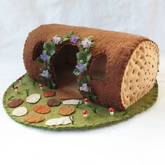 a dog house made out of felt and decorated with flowers