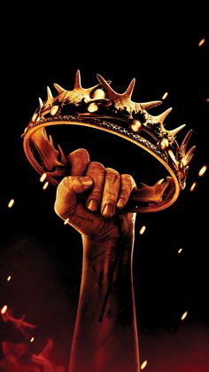 a hand holding a crown with fire coming out of it's middle and the words, game of thrones written below