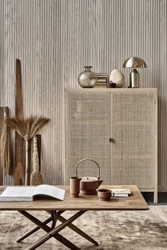 a living room scene with focus on the coffee table and sideboard in the background