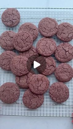 chocolate cookies are arranged on a cooling rack with a video player in the foreground