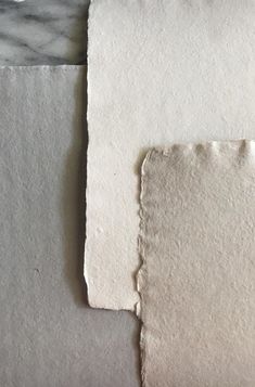 two pieces of white paper on top of each other next to an empty piece of paper