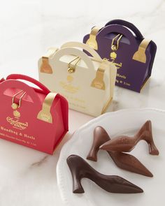 three different types of chocolates on a white plate with a bag in the background