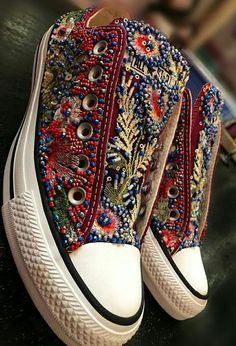 a pair of shoes with colorful beads on them