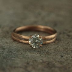 a close up of a ring with a diamond on it