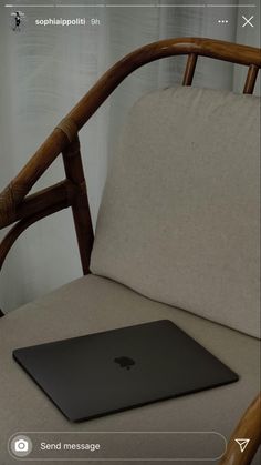 an apple laptop sitting on top of a chair