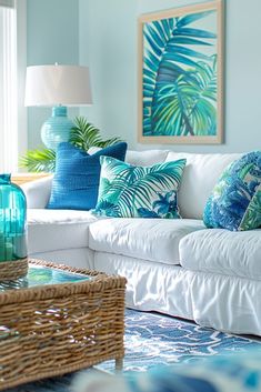 a living room filled with lots of white furniture and colorful pillows on top of it