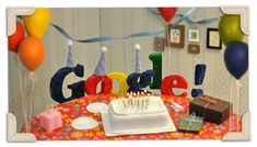 a birthday cake with candles on it sitting in front of the google letters and balloons