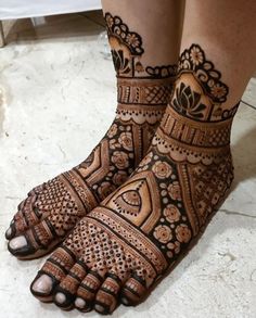 the feet are decorated with henna designs