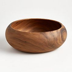 a wooden bowl sitting on top of a white table