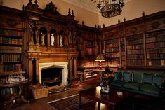 a living room filled with lots of wooden furniture and bookshelves next to a fire place