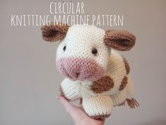 a hand holding a knitted cow with the words circular knitting machine pattern on it