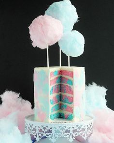 a cake with pink, blue and white frosting