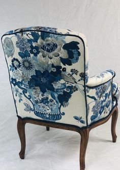 a blue and white chair with flowers on it