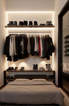 a bedroom with clothes and shoes hanging on the wall, along with a large bed