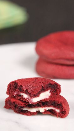 two red velvet cookies with white cream filling