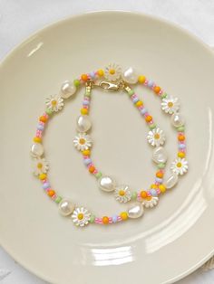 a white plate topped with a necklace and bracelet