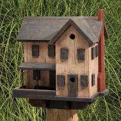 a bird house on top of a wooden post