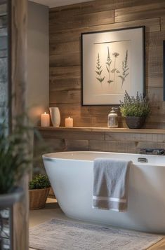 a white bath tub sitting in a bathroom next to a wooden wall with candles on it