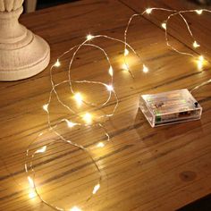 a string of lights sitting on top of a wooden table