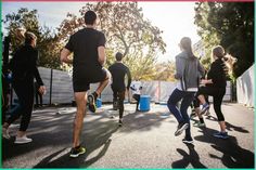 a group of people are running on the street