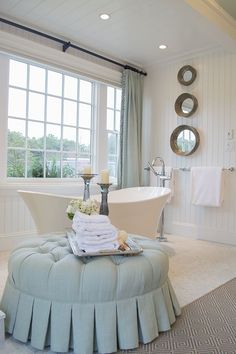 a bath room with a tub a sink and a mirror on the wall next to a window