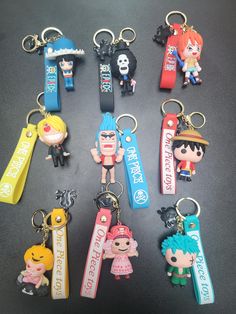 many different key chains with cartoon characters on them