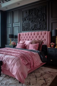 a bedroom with black walls, pink bedding and an upholstered headboard