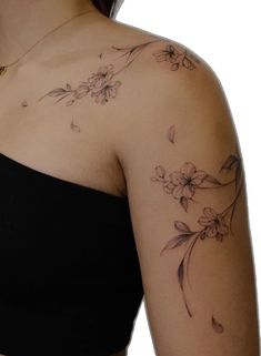 a woman's shoulder with flowers on it