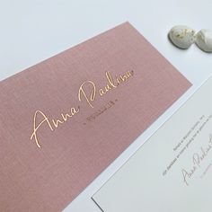 the wedding stationery is pink and gold