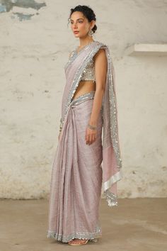 Elevate your look with this handwoven metallic sari, accentuated by a hand-embroidered border in silver. The meticulous craftsmanship adds a touch of sophistication to this ensemble. Complete with a silver hand-embroidered blouse, meticulously crafted with metallic silver using applique and aari techniques. Elegant Resham Embroidered Slub Silk Pre-draped Saree, Elegant Slub Silk Pre-draped Saree With Resham Embroidery, Unstitched Cotton Silk Saree With Mirror Work, Elegant Designer Pre-draped Slub Silk Saree, Elegant Pre-draped Saree With Mirror Work In Cotton Silk, Elegant Cotton Silk Pre-draped Saree With Mirror Work, Elegant Pre-draped Cotton Silk Saree With Mirror Work, Diwali Silver Pre-draped Saree With Mirror Work, Celebration Cotton Silk Saree With Zari Work