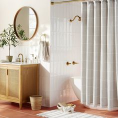 a bath room with a toilet a sink and a mirror