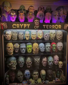 a display case filled with lots of creepy masks