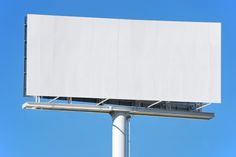 an empty billboard on a pole against a blue sky