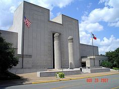 the building has columns and flags on it