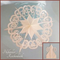 an origami snowflake is shown with the word'hofafati reichenberg '