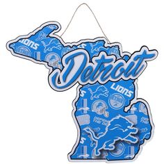 a detroit lions sign hanging from the side of a white wall in front of a white background