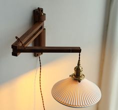 a lamp hanging from the side of a wall