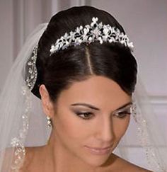 a woman in a wedding dress wearing a tiara