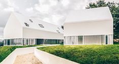 two white houses with grass on the ground