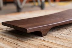 a close up of a wooden object on a wood floor with people in the background