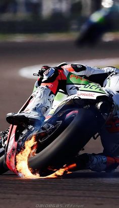 a man riding a motorcycle on top of a race track