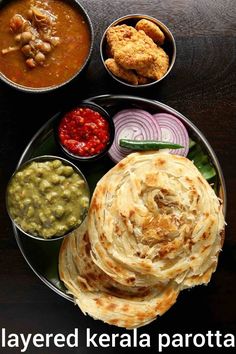 several different types of food on a plate with the words layered kerala parota