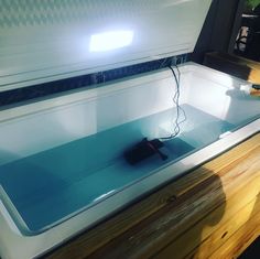 a computer mouse sitting on top of a desk next to a glass tank filled with water