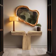 a wooden table with a mirror on it next to a lamp and potted plant